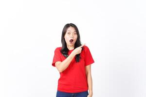 Presenting and Pointing aside with Wow or Shocked Face Expression Of Beautiful Asian Woman wearing red Isolated On White Background photo