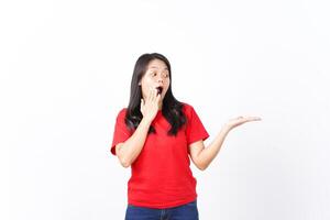 Showing and Presenting on Open Palm with WOW and Shocked Expression Of Beautiful Asian Woman wearing red Isolated On White Background photo
