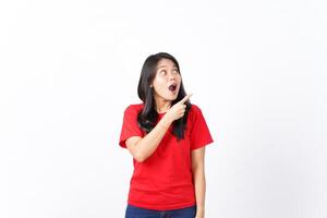 Presenting and Pointing aside with Wow or Shocked Face Expression Of Beautiful Asian Woman wearing red Isolated On White Background photo