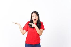Showing and Presenting on Open Palm with WOW and Shocked Expression Of Beautiful Asian Woman wearing red Isolated On White Background photo
