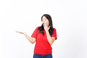 Showing and Presenting on Open Palm with WOW and Shocked Expression Of Beautiful Asian Woman wearing red Isolated On White Background photo