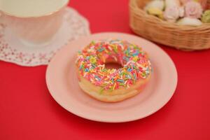 donut and cup on the red table photo