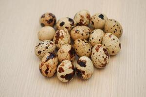 Quail eggs on a wooden table. Close-up, selective focus photo