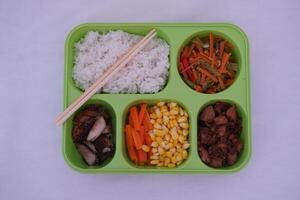 A green tray with five compartments photo