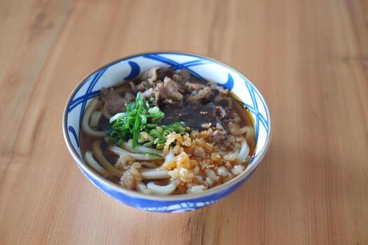 Rice noodle with beef in bowl on wooden table background. photo