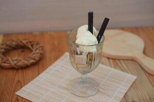Glass filled with ice cream and wafer photo