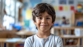 Portrait of a cute little boy smiling at camera in a classroom photo