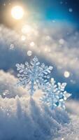 Close-up of two crystal snowflakes on a snowy surface with sunlight and bokeh background. Winter and Christmas concept photo