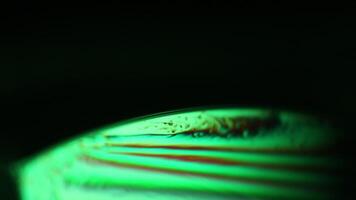 Green liquid lines, green oils on a dark background, colourful abstract, surrealistic art, line of light, blue and green on dark background video