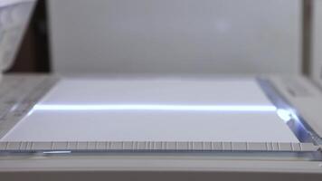 An office scanner performs the process of scanning an A3 document video
