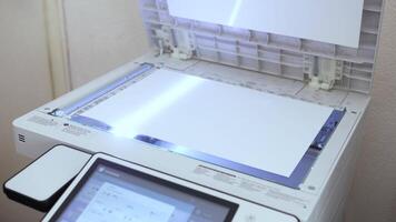 An office scanner performs the process of scanning an A3 document video