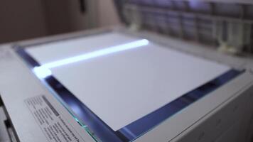 An office scanner performs the process of scanning an A3 document video