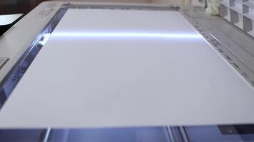 An office scanner performs the process of scanning an A3 document video