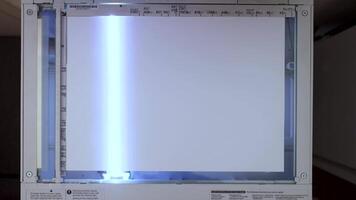 An office scanner performs the process of scanning an A3 document video