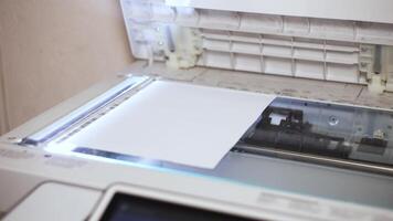 An office scanner performs the process of scanning an A4 document video