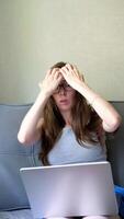 freelancer girl works at home with a laptop and is angry from the number of tasks video