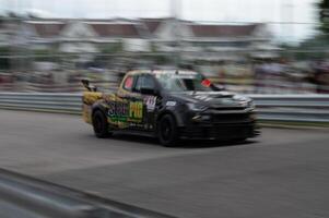 Songkhla, Moung, Thailand Oct 19, 2024 PT Maxnitron Motorsport, Capture thrill of motorsport with dynamic image of high-speed racing car, expertly navigating track photo