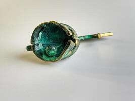 Bell in the form of an ancient Greek helmet made of bronze on a white background. photo