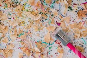 Image of sharpening coloured pencil. Creative school background idea. Aesthetic art concept. Colorful backdrop flat lay. photo