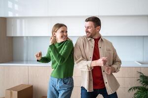 Excited family dancing, ready to unpack boxes in new home, moving together. Mortgage loan, renting photo