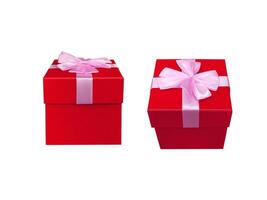 Red gift box tied with a pink bow on a white background. photo