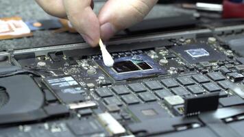 Cleaning old thermal paste from the computer CPU or GPU processor. Hardware service for the computer repair video