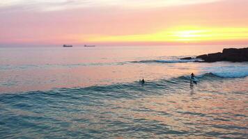 Serene Sunset Over Ocean Waves With Surfers Enjoying the Evening Surf in Portugal video