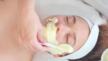 Cosmetologist applying alginate mask to client in spa video