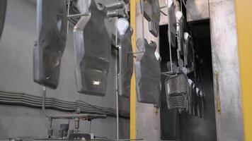 A large machine with several metal pieces hanging from it video