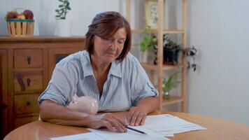 Organizing Personal Finances at Home With a Piggy Bank on the Table in a Cozy Setting video