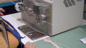 A person is working on a machine that is making a piece of string video