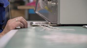 A person working on a machine with a piece of string video