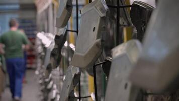 A man is walking through a factory with many chairs video