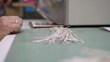 A person is cutting up some white wires video