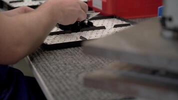 A man is working on a machine in a factory video