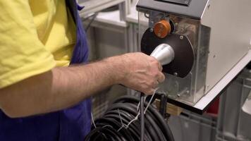 A man is using a machine to connect wires video