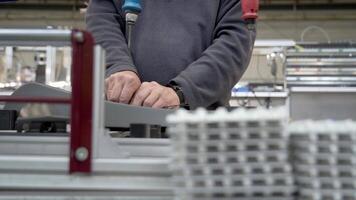 A man working on a machine in a factory video