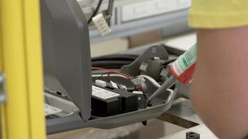 A person is working on a machine with a battery video