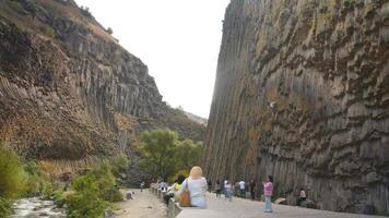 Garni, Armenia - 15th october, 2024 - visitors sightseeing popular travel destination in armenia - Basalt columns in Garni Gorge. Symphony of Stones. Geological formation of octagonal basalt columns video