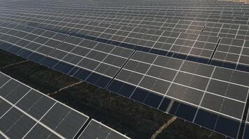 Aerial fly over view of industrial sized solar panel farm. Close-up of Solar cell farm power plant eco technology.Concept of sustainable resources and renewable energy video