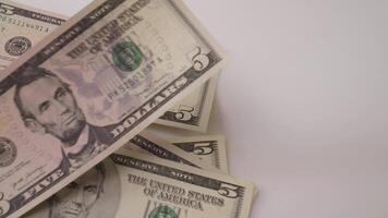 timelapse dollars bills falling on white table background video