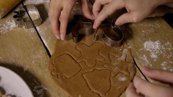 Top view of round piece of brown dough, which is used to create various shapes of Christmas gingerbread using metal molds. Close up. Top view. video
