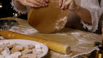 The pastry chef gently turns a piece of chocolate dough over and levels it using a skipping rope to give it a rounded shape. video