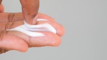 Closeup view of a moisturizing routine showing the application of skincare cream on hands video