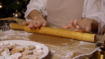Pastry chef uses skipping rope to help smooth and shape brown ginger chocolate dough, which will be used to make Christmas gingerbread. Close up video