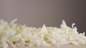 A Beautiful Display of Freshly Shredded Cheese Resting on a Wooden Surface video