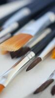 A Variety of Assorted Paintbrushes on Canvas Set Against Colorful Backgrounds video