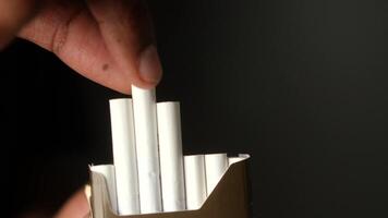 This is a closeup image of a cigarette pack that contains white cigarettes video