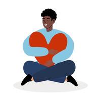 Young man happily embraces a large heart symbol while sitting on the floor vector