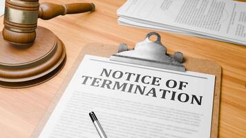 Wooden Lawyer Desk with Highlighted Word 'NOTICE OF TERMINATION' on Clipboards Documents on Table. Judge's Wooden Gavel Knocking and Court Making Decision on 'NOTICE OF TERMINATION' in Courtroom. video